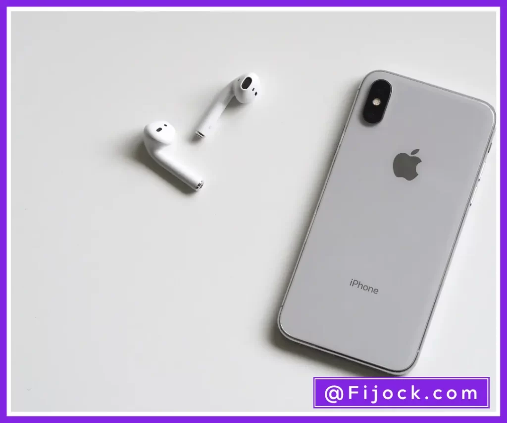 Gray color iPhone and a pair of white apple airpods
